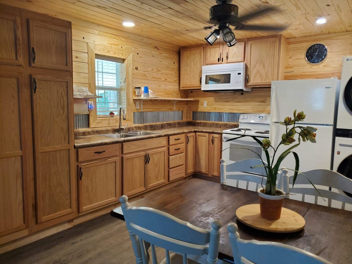 Cozy wooden kitchen with modern appliances and rustic charm.