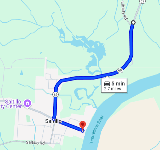 Map showing a 5-minute route from a highway to a destination near a river.