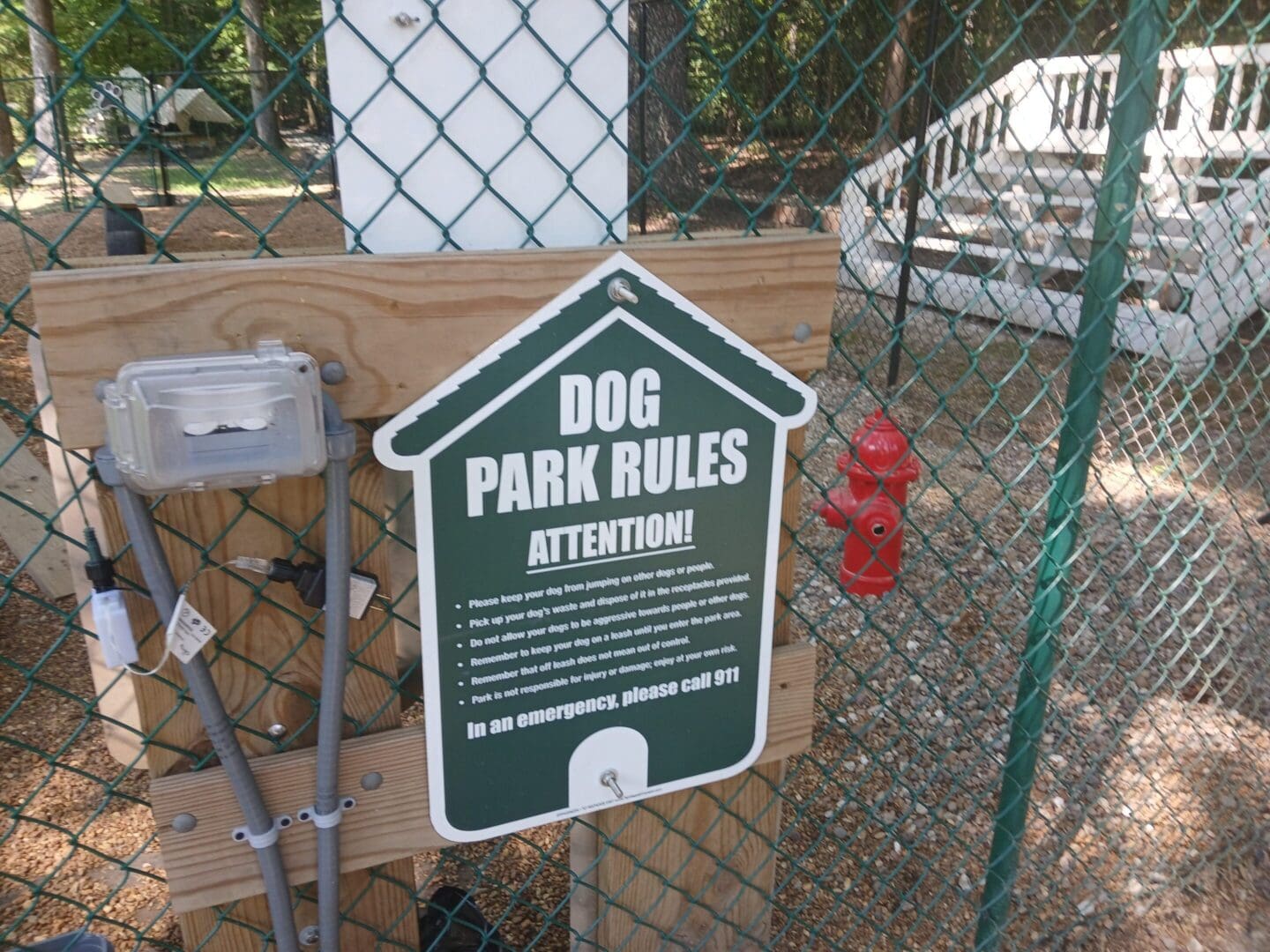 Dog park rules sign on fence.