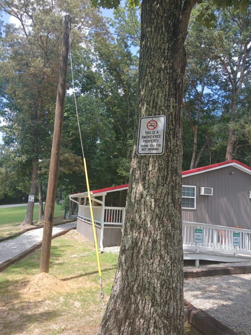 Tree with no trespassing sign near building.