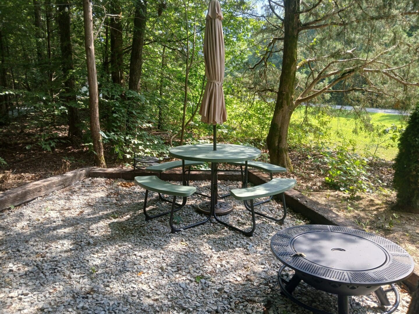 Outdoor picnic table and fire pit area.