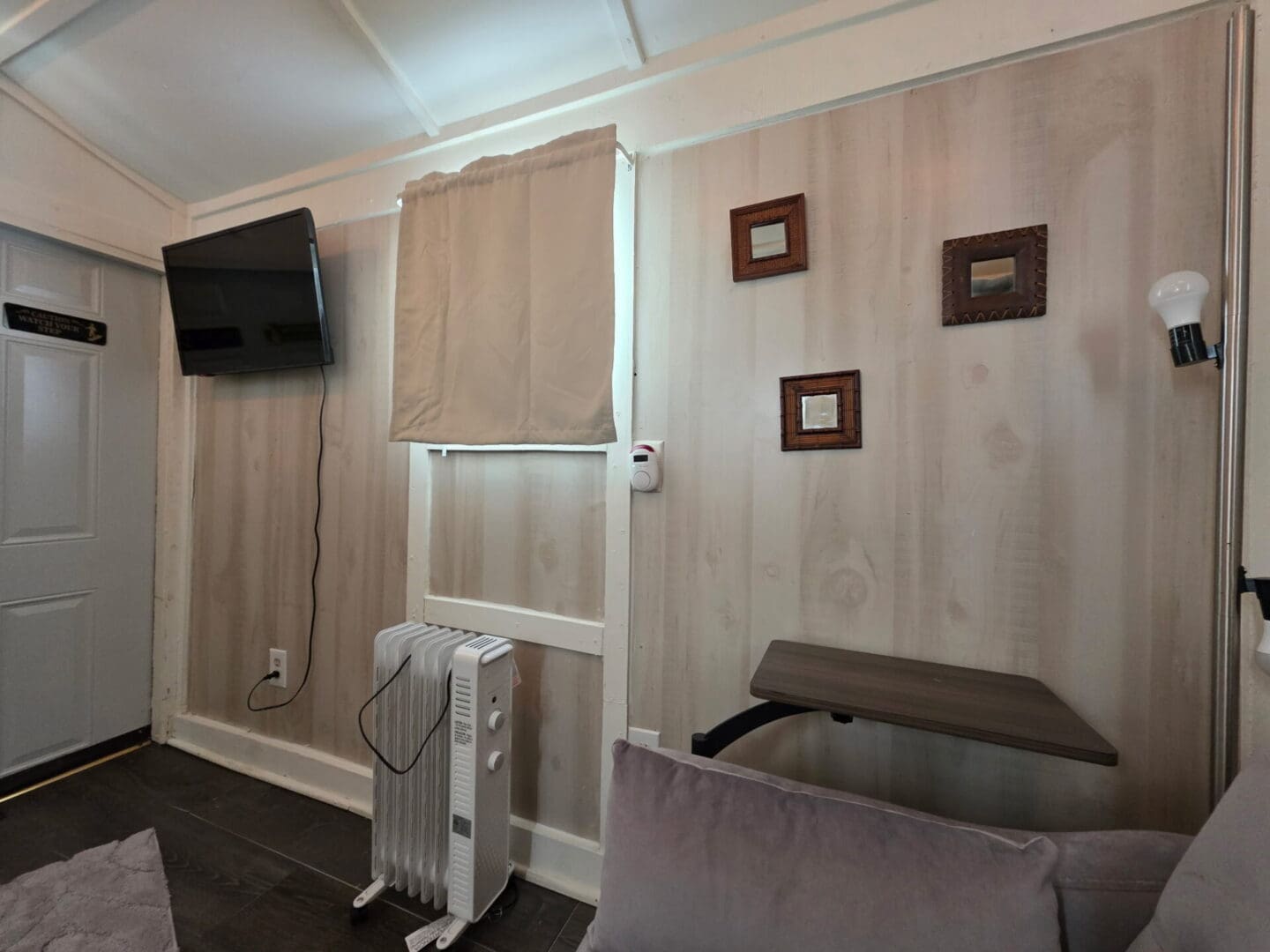 Small living room with wall TV and heater