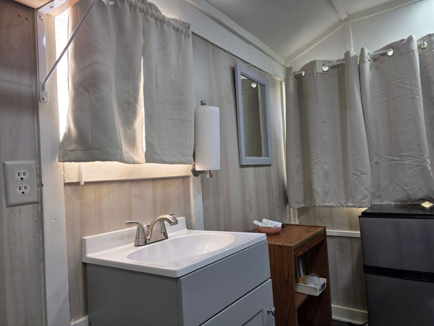 Compact sink area with mini fridge and shelf
