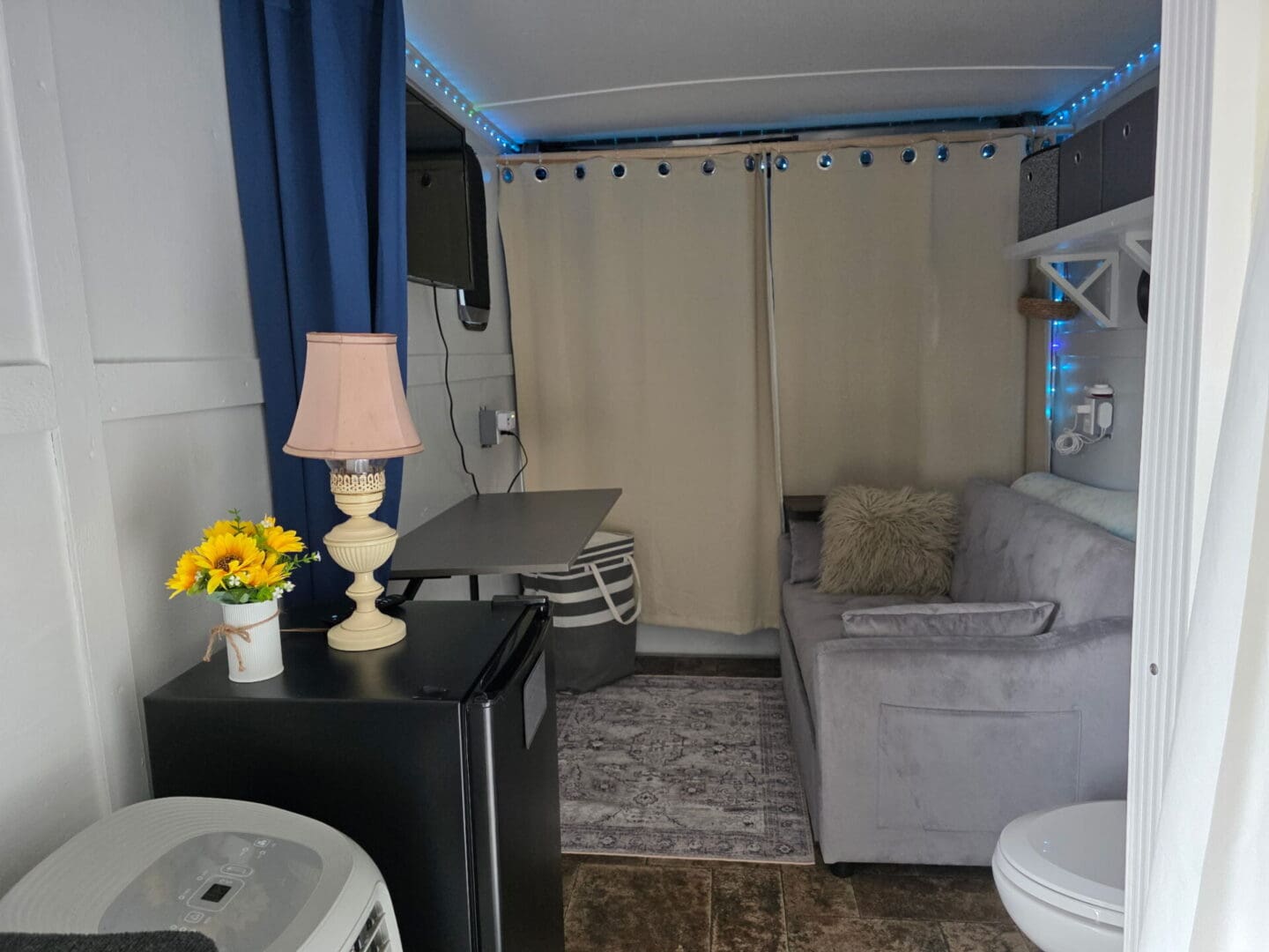 Cozy tiny living space with couch and lamp