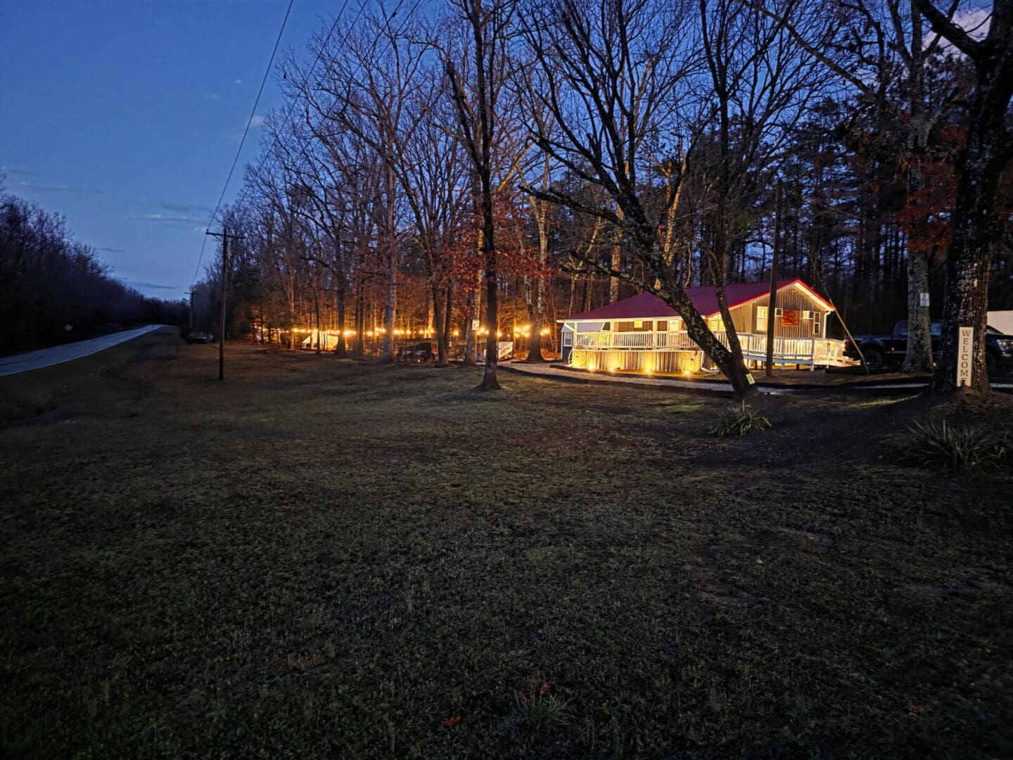 Lit cabin with string lights at dusk