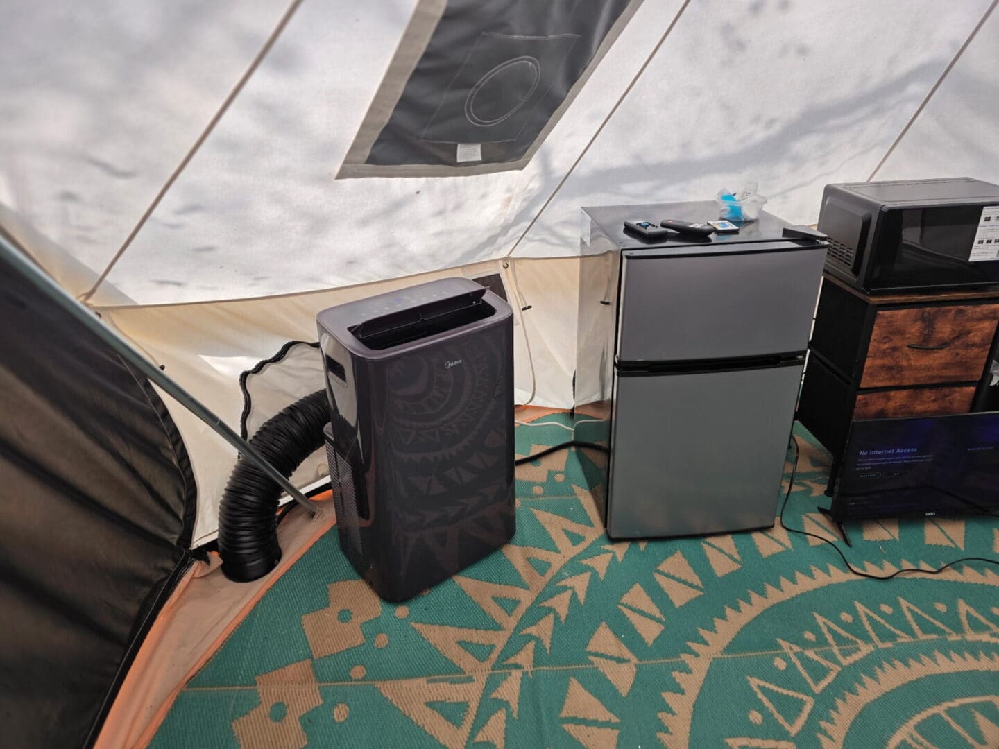 Portable AC and mini fridge inside tent