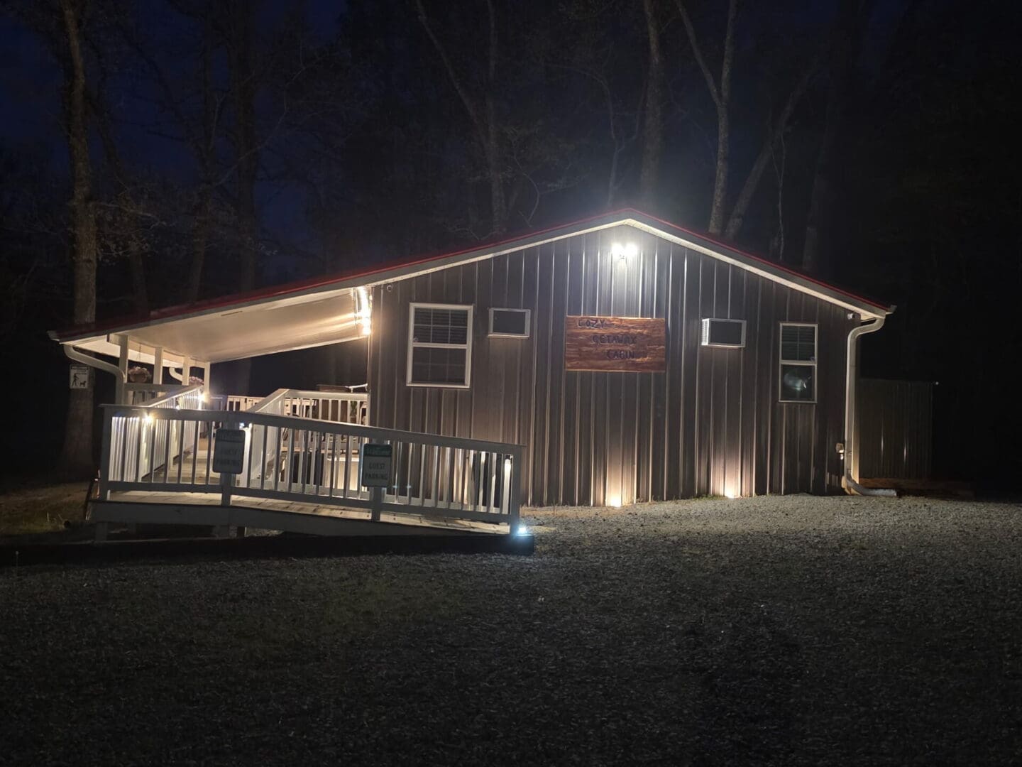 Illuminated cabin with ramp at night
