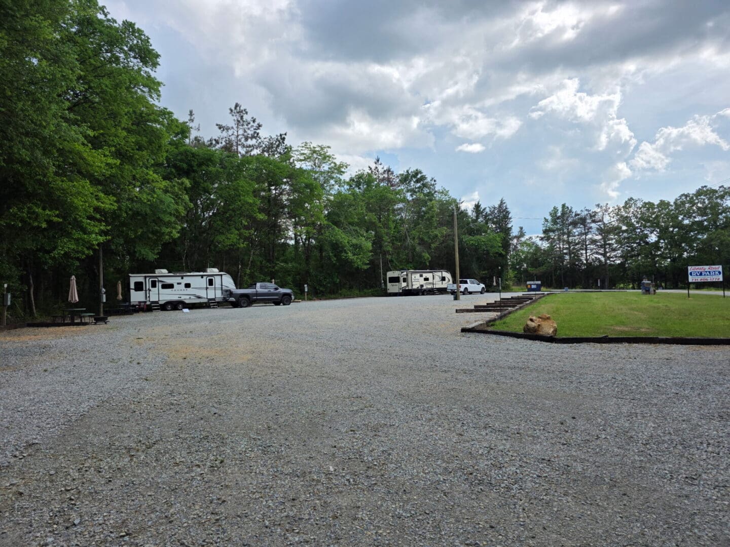RV park with trailers under cloudy sky