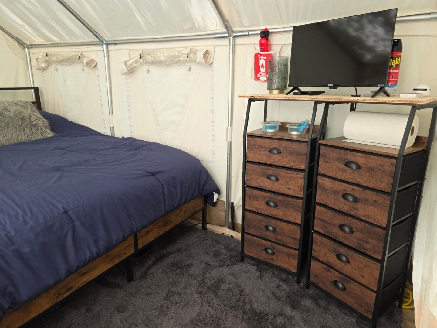 Cozy tent interior with bed and drawers