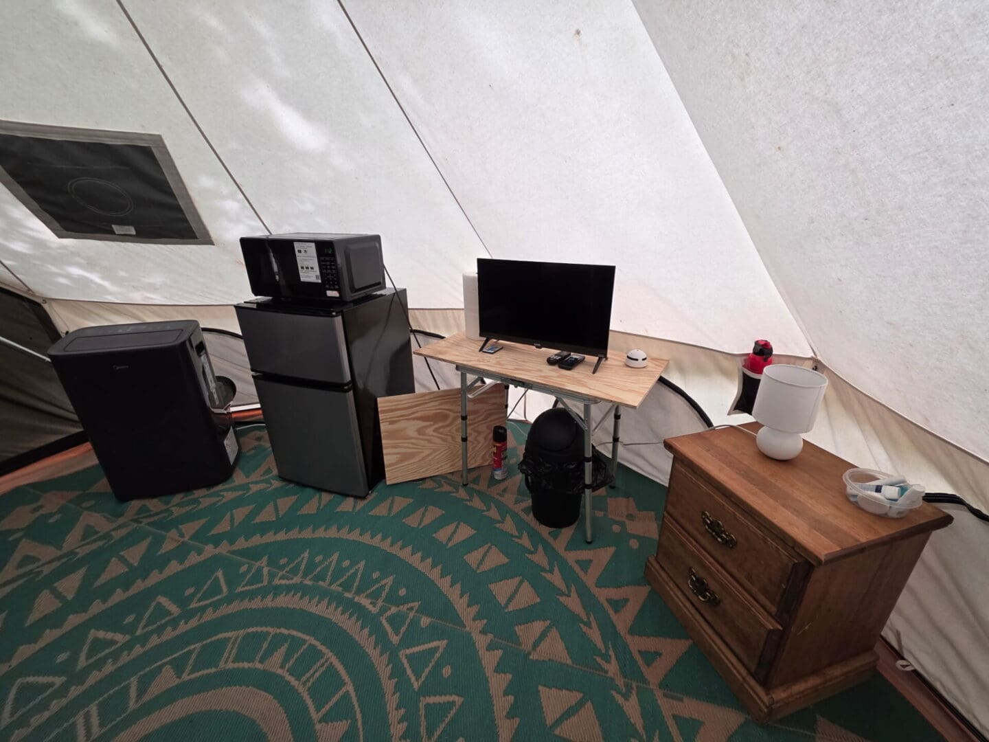 Tent interior with TV, refrigerator, microwave